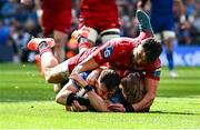 31 May 2025; Hugo Keenan of Leinster scores his side's fourth try, despte the tackle to Scarlets players Johnny Williams and Blair Murray, during the United Rugby Championship quarter-final match between Leinster and Scarlets at the Aviva Stadium in Dublin. Photo by Seb Daly/Sportsfile