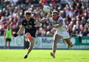 31 May 2025; Micheal Rooney of Down in action against Conor Grimes of Louth during the GAA Football All-Ireland Senior Championship Round 2 match between Down and Louth at Páirc Esler in Newry, Down. Photo by Daire Brennan/Sportsfile