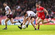 1 June 2025; Seán Kelly of Galway in action against Niall Loughlin of Derry during the GAA Football All-Ireland Senior Championship Round 2 match between Derry and Galway at Celtic Park in Derry. Photo by Piaras Ó Mídheach/Sportsfile