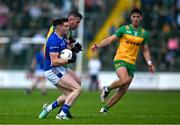 1 June 2025; Cian Reilly of Cavan is tackled by Patrick McBrearty of Donegal during the GAA Football All-Ireland Senior Championship Round 2 match between Cavan and Donegal at Kingspan Breffni in Cavan. Photo by Brendan Moran/Sportsfile