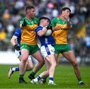 1 June 2025; Cian Reilly of Cavan is tackled by Patrick McBrearty and Michael Langan of Donegal during the GAA Football All-Ireland Senior Championship Round 2 match between Cavan and Donegal at Kingspan Breffni in Cavan. Photo by Brendan Moran/Sportsfile