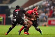 31 May 2025; John Hodnett of Munster is tackled by Ox Nche of Hollywoodbets Sharks and Bongi Mbonambi of Hollywoodbets Sharks during the United Rugby Championship quarter-final match between Hollywoodbets Sharks and Munster at Kings Park Stadium in Durban, South Africa. Photo by Shaun Roy/Sportsfile