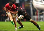 31 May 2025; Calvin Nash of Munster gets his kick away as Vincent Tshituka of Hollywoodbets Sharks makes the tackle during the United Rugby Championship quarter-final match between Hollywoodbets Sharks and Munster at Kings Park Stadium in Durban, South Africa. Photo by Shaun Roy/Sportsfile