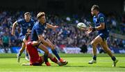 31 May 2025; Jordie Barrett of Leinster off-loads to teammate Hugo Keenan as he is tackled by Joe Roberts of Scarlets during the United Rugby Championship quarter-final match between Leinster and Scarlets at the Aviva Stadium in Dublin. Photo by Seb Daly/Sportsfile