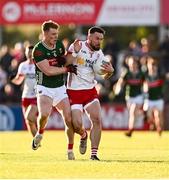 31 May 2025; Peter Teague of Tyrone in action against David McBrien of Mayo during the GAA Football All-Ireland Senior Championship Round 2 match between Tyrone and Mayo at O'Neills Healy Park in Omagh, Tyrone. Photo by Piaras Ó Mídheach/Sportsfile
