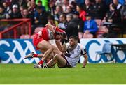 1 June 2025; Ciarán McFaul of Derry tussles off the ball with Damien Comer of Galway as Comer makes his way onto the pitch as a substitute during the GAA Football All-Ireland Senior Championship Round 2 match between Derry and Galway at Celtic Park in Derry. Photo by Piaras Ó Mídheach/Sportsfile