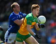 1 June 2025; Ciarán Moore of Donegal is tackled by Padraig Faulkner of Cavan during the GAA Football All-Ireland Senior Championship Round 2 match between Cavan and Donegal at Kingspan Breffni in Cavan. Photo by Brendan Moran/Sportsfile