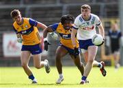 1 June 2025; Mícheál McCarville of Monaghan in action against Clare players, from left, Conor Meaney, and Ikem Ugweuru uring the GAA Football All-Ireland Senior Championship Round 2 match between Monaghan and Clare at St Tiernach’s Park in Clones, Monaghan. Photo by Michael P Ryan/Sportsfile