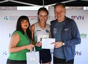 1 June 2025; Fifth place finisher Sheila O'Byrne of Parnell AC is presented with her awards by Lauren McCausland of Bauer Media, and David O'Leary, General Manager, Women's Mini Marathon, after the 2025 Vhi Women’s Mini Marathon. More than 28,500 women from all over the country took to the streets of Dublin to run, walk and jog the 10km route, raising much needed funds for hundreds of charities. For further information please log on to www.vhiwomensminimarathon.ie Photo by Seb Daly/Sportsfile