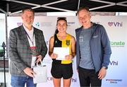 1 June 2025; Fourth place finisher Aoibhe Richardson of Kilkenny City Harriers is presented with her awards by Dean Flynn of Citizen, and David O'Leary, General Manager, Women's Mini Marathon, after the 2025 Vhi Women’s Mini Marathon. More than 28,500 women from all over the country took to the streets of Dublin to run, walk and jog the 10km route, raising much needed funds for hundreds of charities. For further information please log on to www.vhiwomensminimarathon.ie Photo by Seb Daly/Sportsfile