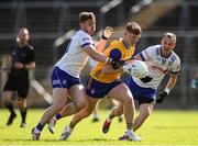 1 June 2025; Dermot Coughlan of Clare in action against Monaghan players, from left, Mícheál Bannigan and Jack McCarron during the GAA Football All-Ireland Senior Championship Round 2 match between Monaghan and Clare at St Tiernach’s Park in Clones, Monaghan. Photo by Michael P Ryan/Sportsfile