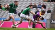1 June 2025; Gavin Sheehan of Wexford is tackled by Conor McGee and Josh Largo Elis, left, of Fermanagh during the Tailteann Cup match between Fermanagh and Wexford at Croke Park in Dublin. Photo by Ray McManus/Sportsfile