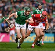 7 June 2025; William O'Donoghue of Limerick is tackled by Ciarán Joyce of Cork during the Munster GAA Hurling Senior Championship final match between Limerick and Cork at LIT Gaelic Grounds in Limerick. Photo by Ray McManus/Sportsfile
