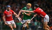 7 June 2025; Adam English of Limerick is tackled by Eoin Downey and Seán O'Donoghue of Cork, left, during the Munster GAA Hurling Senior Championship final match between Limerick and Cork at LIT Gaelic Grounds in Limerick. Photo by Ray McManus/Sportsfile