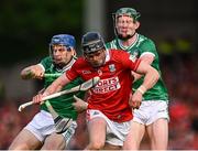 7 June 2025; Darragh Fitzgibbon of Cork is tackled by Michael Casey and William O'Donoghue of Limerick during the Munster GAA Hurling Senior Championship final match between Limerick and Cork at TUS Gaelic Grounds in Limerick. Photo by Ray McManus/Sportsfile