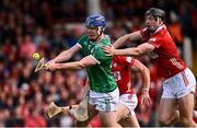 7 June 2025; Shane O'Brien of Limerick shoots to score his side's second goal, under pressure from Eoin Downey of Cork, during the Munster GAA Hurling Senior Championship final match between Limerick and Cork at TUS Gaelic Grounds in Limerick. Photo by Piaras Ó Mídheach/Sportsfile