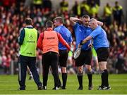 7 June 2025; Referee Thomas Walsh, third from left, receives medical attention for an injury as he's replaced by standy referee James Owens, second from right, during the Munster GAA Hurling Senior Championship final match between Limerick and Cork at TUS Gaelic Grounds in Limerick. Photo by Piaras Ó Mídheach/Sportsfile