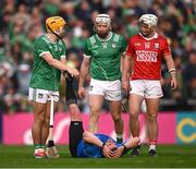7 June 2025; Cian Lynch of Limerick and Tommy O'Connell of Cork look on as referee Thomas Walsh is attended to by Adam English of Limerick during the Munster GAA Hurling Senior Championship final match between Limerick and Cork at TUS Gaelic Grounds in Limerick. Photo by Ray McManus/Sportsfile