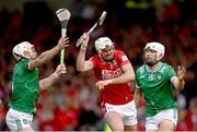 7 June 2025; Tim O'Mahony of Cork is tackled by Cian Lynch, left, and Aaron Gillane of Limerick during the Munster GAA Hurling Senior Championship final match between Limerick and Cork at TUS Gaelic Grounds in Limerick. Photo by Ray McManus/Sportsfile