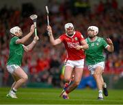 7 June 2025; Tim O'Mahony of Cork is tackled by Cian Lynch, left, and Aaron Gillane of Limerick during the Munster GAA Hurling Senior Championship final match between Limerick and Cork at TUS Gaelic Grounds in Limerick. Photo by Ray McManus/Sportsfile