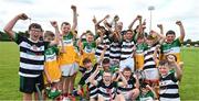 10 June 2025; Uachtarán Chumann Lúthchleas Gael Jarlath Burns and pupils of St Brendan's National School, Birr as the celebrate a notional victory with the Liam MacCarthy cup at the national launch of the GAA Hurling All-Ireland Senior Championship Series at GAA Faithful Fields Offaly Centre of Excellence, Kilcormac in Offaly. Photo by Ray McManus/Sportsfile