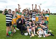 10 June 2025; Uachtarán Chumann Lúthchleas Gael Jarlath Burns and pupils of St Brendan's National School, Birr as the celebrate a notional victory with the Liam MacCarthy cup at the national launch of the GAA Hurling All-Ireland Senior Championship Series at GAA Faithful Fields Offaly Centre of Excellence, Kilcormac in Offaly. Photo by Ray McManus/Sportsfile