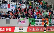 10 June 2025; Luxembourg supporters hold up red cards during the international friendly match between Luxembourg and Republic of Ireland at Stade de Luxembourg in Luxembourg. Photo by Stephen McCarthy/Sportsfile
