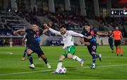 10 June 2025; Troy Parrott of Republic of Ireland in action against Seid Korac, left, and Eldin Dzogovic of Luxembourg during the international friendly match between Luxembourg and Republic of Ireland at Stade de Luxembourg in Luxembourg. Photo by Stephen McCarthy/Sportsfile