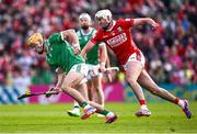 7 June 2025; Adam English of Limerick in action against Tim O'Mahony of Cork during the Munster GAA Hurling Senior Championship final match between Limerick and Cork at TUS Gaelic Grounds in Limerick. Photo by Piaras Ó Mídheach/Sportsfile