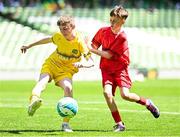 11 June 2025; Callum Griffin of Scoil Bhríde, Mullaghrafferty, Monaghan, in action against Conall Earley of Clonmoney NS, Newmarket on Fergus, Clare, during the FAI Primary 5s Finals Day at the Aviva Stadium in Dublin. Photo by Seb Daly/Sportsfile