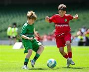 11 June 2025; Kevin Timlin of Cornafulla NS, Roscommon, left, in action against Rian O’Connor of Clonmoney NS, Newmarket on Fergus, Clare, during the FAI Primary 5s Finals Day at the Aviva Stadium in Dublin. Photo by Seb Daly/Sportsfile