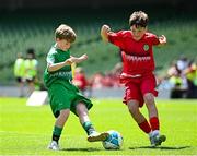 11 June 2025; Kevin Timlin of Cornafulla NS, Roscommon, left, in action against Rian O’Connor of Clonmoney NS, Newmarket on Fergus, Clare, during the FAI Primary 5s Finals Day at the Aviva Stadium in Dublin. Photo by Seb Daly/Sportsfile