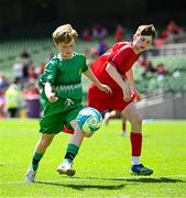 11 June 2025; Kevin Timlin of Cornafulla NS, Roscommon, left, in action against Matthew Murphy of Clonmoney NS, Newmarket on Fergus, Clare, during the FAI Primary 5s Finals Day at the Aviva Stadium in Dublin. Photo by Seb Daly/Sportsfile