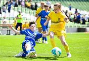 11 June 2025; Max Kearns of Kentstown NS, Meath, left, in action against Rian McEneaney of Scoil Bhríde, Mullaghrafferty, Monaghan, during the FAI Primary 5s Finals Day at the Aviva Stadium in Dublin. Photo by Seb Daly/Sportsfile