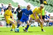 11 June 2025; Austin Barry of Kentstown NS, Meath, in action against Callum Mullen of Scoil Bhríde, Mullaghrafferty, Monaghan, during the FAI Primary 5s Finals Day at the Aviva Stadium in Dublin. Photo by Seb Daly/Sportsfile