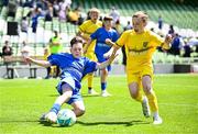 11 June 2025; Max Kearns of Kentstown NS, Meath, left, in action against Rian McEneaney of Scoil Bhríde, Mullaghrafferty, Monaghan, during the FAI Primary 5s Finals Day at the Aviva Stadium in Dublin. Photo by Seb Daly/Sportsfile