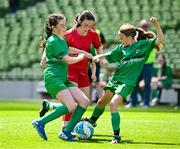 11 June 2025; Skye Collins of Gaelscoil Uí Drisceoil, Corcaigh, centre, in action against Saoirse Ní Mháirtín and Ruby Ní Mhaonaigh of Scoil Fhursa, Gaillimh, during the FAI Primary 5s Finals Day at the Aviva Stadium in Dublin. Photo by Seb Daly/Sportsfile