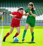 11 June 2025; Bláthnaid McNally of Gaelscoil Uí Drisceoil, Corcaigh, left, in action against Saoirse Ní Mháirtín of Scoil Fhursa, Gaillimh, during the FAI Primary 5s Finals Day at the Aviva Stadium in Dublin. Photo by Seb Daly/Sportsfile