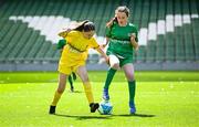 11 June 2025; Saoirse Ní Mháirtín of Scoil Fhursa, Gaillimh, right, in action against Leona Fitzpatrick of St Felim’s NS, Ballinagh, Cavan, during the FAI Primary 5s Finals Day at the Aviva Stadium in Dublin. Photo by Seb Daly/Sportsfile