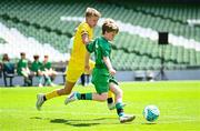 11 June 2025; Kevin Timlin of Cornafulla NS, Roscommon, right, in action against Callum Mullen of Scoil Bhríde, Mullaghrafferty, Monaghan, during the FAI Primary 5s Finals Day at the Aviva Stadium in Dublin. Photo by Seb Daly/Sportsfile