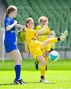 11 June 2025; Éadaoin Nic Meanaman of Scoil Náisiúnta an Choimín, Dún na nGall, right, in action against Aimee Hickey of St Leonard’s NS, Dunnamaggin, Kilkenny, during the FAI Primary 5s Finals Day at the Aviva Stadium in Dublin. Photo by Seb Daly/Sportsfile