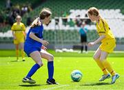 11 June 2025; Sinéad Nic Meanaman of Scoil Náisiúnta an Choimín, Dún na nGall, right, in action against Keira Lyons of St Leonard’s NS, Dunnamaggin, Kilkenny, during the FAI Primary 5s Finals Day at the Aviva Stadium in Dublin. Photo by Seb Daly/Sportsfile