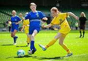 11 June 2025; Sinéad Nic Meanaman of Scoil Náisiúnta an Choimín, Dún na nGall, right, in action against Aimee Hickey of St Leonard’s NS, Dunnamaggin, Kilkenny, during the FAI Primary 5s Finals Day at the Aviva Stadium in Dublin. Photo by Seb Daly/Sportsfile