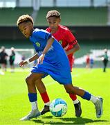11 June 2025; Kyan Ó Foghlú of Gaelscoil Uí Chéadaigh, Wicklow, right, in action against Kingsley Crosby of Rathmore NS, Baltimore, Cork, during the FAI Primary 5s Finals Day at the Aviva Stadium in Dublin. Photo by Seb Daly/Sportsfile