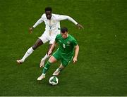 6 June 2025; Jason Knight of Republic of Ireland in action against Boulaye Dia of Senegal during the international friendly match between Republic of Ireland and Senegal at the Aviva Stadium in Dublin. Photo by Piaras Ó Mídheach/Sportsfile