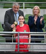 11 June 2025; Aoife Halley of Monaleen NS, Limerick, is presented with her Player of the Tournament award for the girls section C cup, for large sized schools, by FAI president Paul Cooke and FAI board member Caroline Rhatigan during the FAI Primary 5s Finals Day at the Aviva Stadium in Dublin. Photo by Seb Daly/Sportsfile