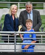 11 June 2025; Miki Jachymczak of Lusk SNS, Dublin, is presented with his Player of the Tournament award for the section C cup, for mixed large sized schools, by FAI board member Caroline Rhatigan and FAI president Paul Cooke  during the FAI Primary 5s Finals Day at the Aviva Stadium in Dublin. Photo by Seb Daly/Sportsfile