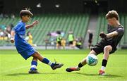 11 June 2025; Jamie Walsh of Lusk SNS, Dublin, have a shot on goal saved by Aaron Lennon of Scoil Íosa, Oranmore, Galway, during the FAI Primary 5s Finals Day at the Aviva Stadium in Dublin. Photo by Seb Daly/Sportsfile