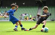 11 June 2025; Jamie Walsh of Lusk SNS, Dublin, have a shot on goal saved by Aaron Lennon of Scoil Íosa, Oranmore, Galway, during the FAI Primary 5s Finals Day at the Aviva Stadium in Dublin. Photo by Seb Daly/Sportsfile