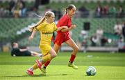 11 June 2025; Esme McDonald of Monaleen NS, Limerick, in action against Anna Doherty of Scoil Íosagáin, Buncrana, Inishowen, Donegal, during the FAI Primary 5s Finals Day at the Aviva Stadium in Dublin. Photo by Seb Daly/Sportsfile